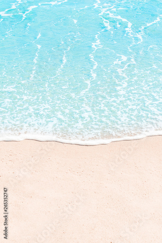 Soft wave of blue sea on sandy beach. Summer Background. Copyspace