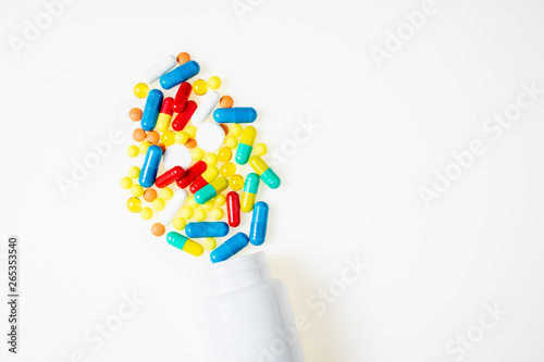 Pill bottle with assorted pharmaceutical medicine pills  tablets  capsules on white background top view. Medical pharmacy background. Flat lay