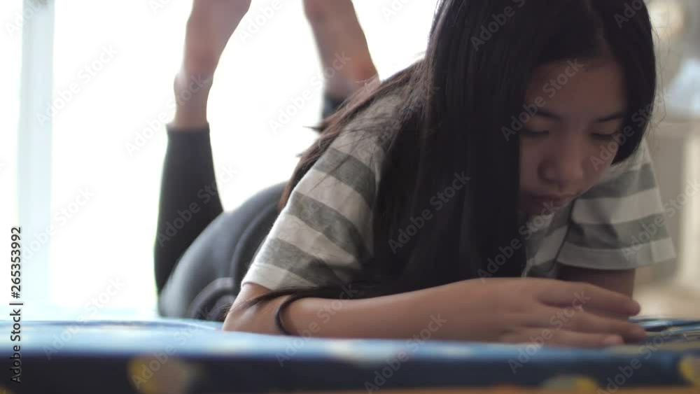 Asian girl using mobile phone for playing game and talking with mother