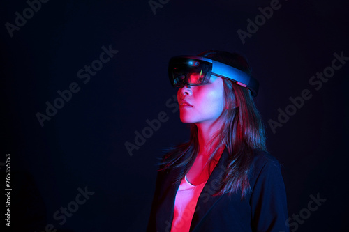 Business woman try vr glasses hololens in the dark room | Portrait of young asian girl experience ar | Future technology concept