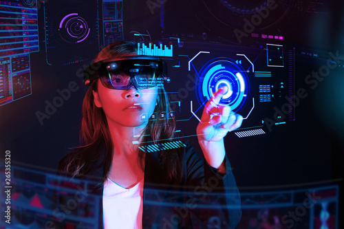 Business woman try vr glasses hololens in the dark room | Portrait of young asian girl experience ar communication | Future technology concept