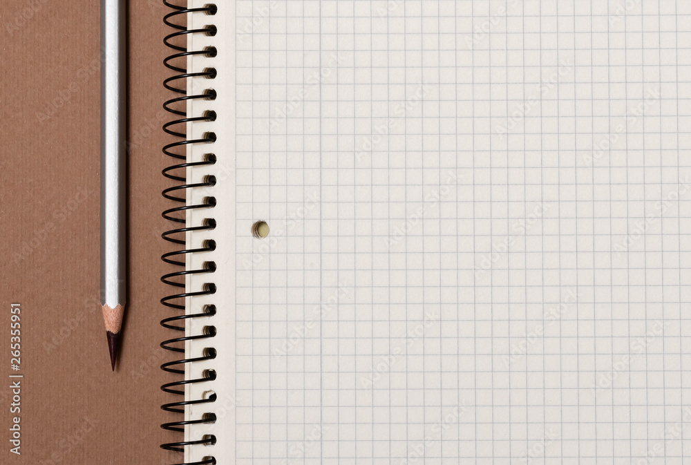 white checked notebook and gray pencil closeup white checked notebook and gray pencil closeup