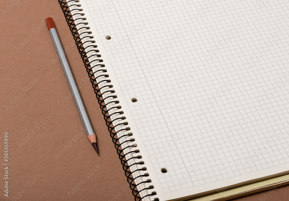 white checked notebook and gray pencil closeup white checked notebook and gray pencil closeup