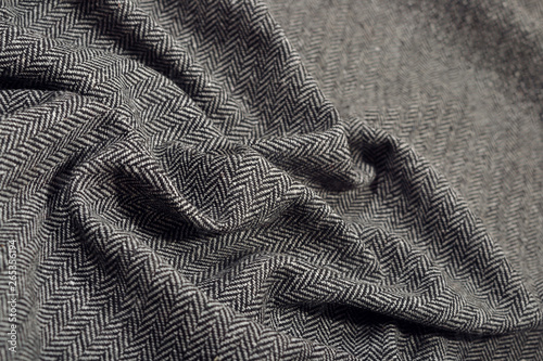 Draped herringbone tweed wool fabric texture