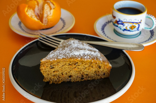 Sweet  spicy carrot cake  coffee and tangerine on orange background