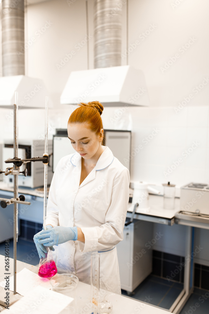 A young girl conducting experiments in a scientific laboratory. A young scientist in a modern laboratory. Student in the lab. A young girl conducting experiments in a scientific laboratory. A young scientist in a modern laboratory. Student in the lab.