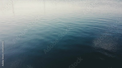 Full frame view of a soothing and calm blue sea surface.