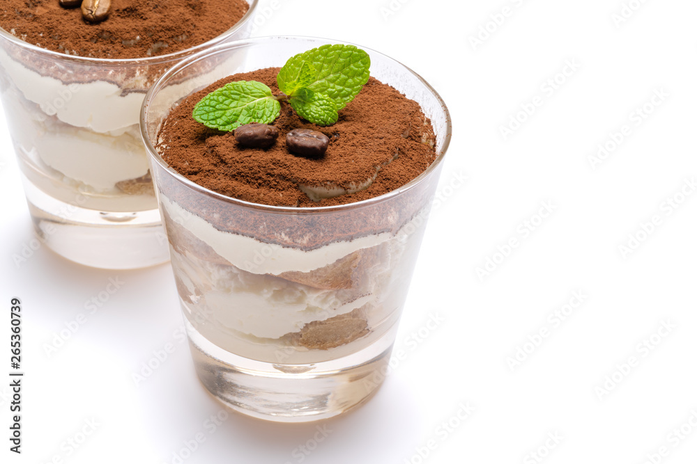 two portions Classic tiramisu dessert in a glass isolated on a white background with clipping path two portions Classic tiramisu dessert in a glass isolated on a white background with clipping path