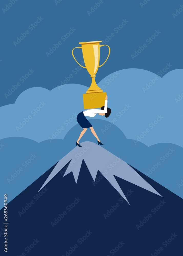 business lady on top of a mountain carries a very heavy prize cup