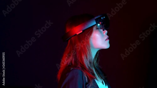 Business woman try vr glasses hololens in the dark room | Portrait of young asian girl experience ar communication | Future technology concept