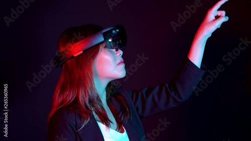 Business woman try vr glasses hololens in the dark room | Portrait of young asian girl experience ar communication | Future technology concept