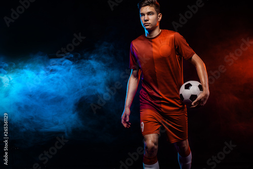 Teenager - soccer player. Boy in football sportswear after game with ball. Sport concept.