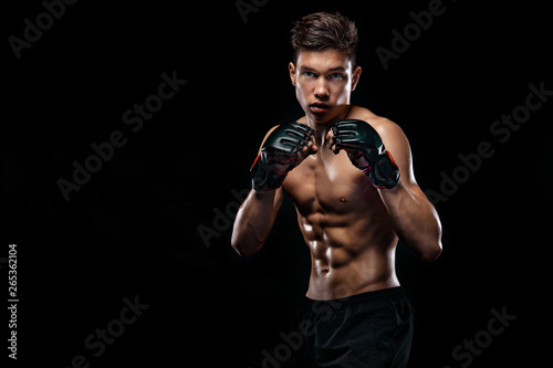 Sportsman man boxer fighting on black background with shadow. Copy Space. Boxing sport concept.