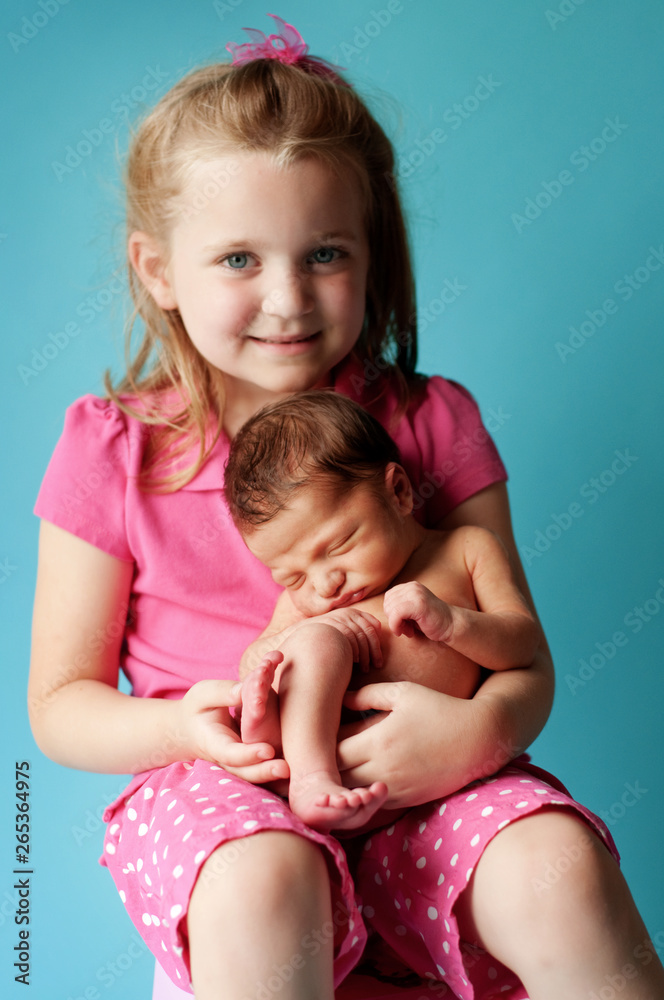 Newborn Baby Held by Big Sister Newborn Baby Held by Big Sister