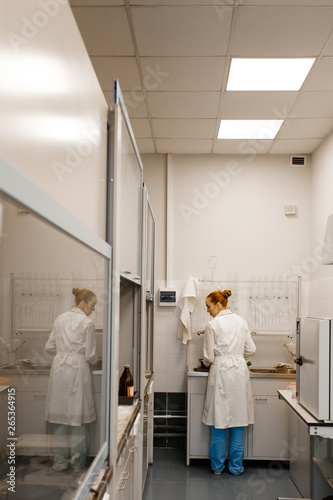 Young student in a modern laboratory. standing by the sink. The photo illustrates science and education.