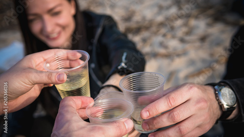 04.27.2019 - Vyshgorod, Ukraine. The friends drink white wine at a picnic photo