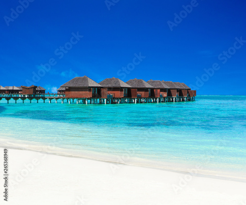 tropical Maldives island with white sandy beach and sea