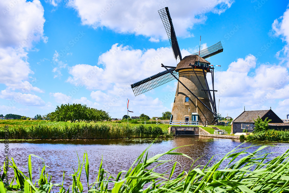 Netherlands rural lanscape with windmills at famous tourist site Kinderdijk in Holland. Old Dutch village Kinderdijk, UNESCO world heritage site. 