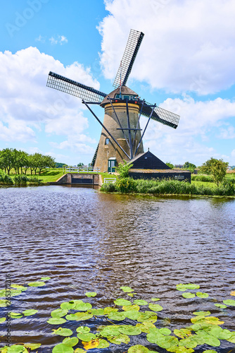 Netherlands rural lanscape with windmills at famous tourist site Kinderdijk in Holland. Old Dutch village Kinderdijk, UNESCO world heritage site. 