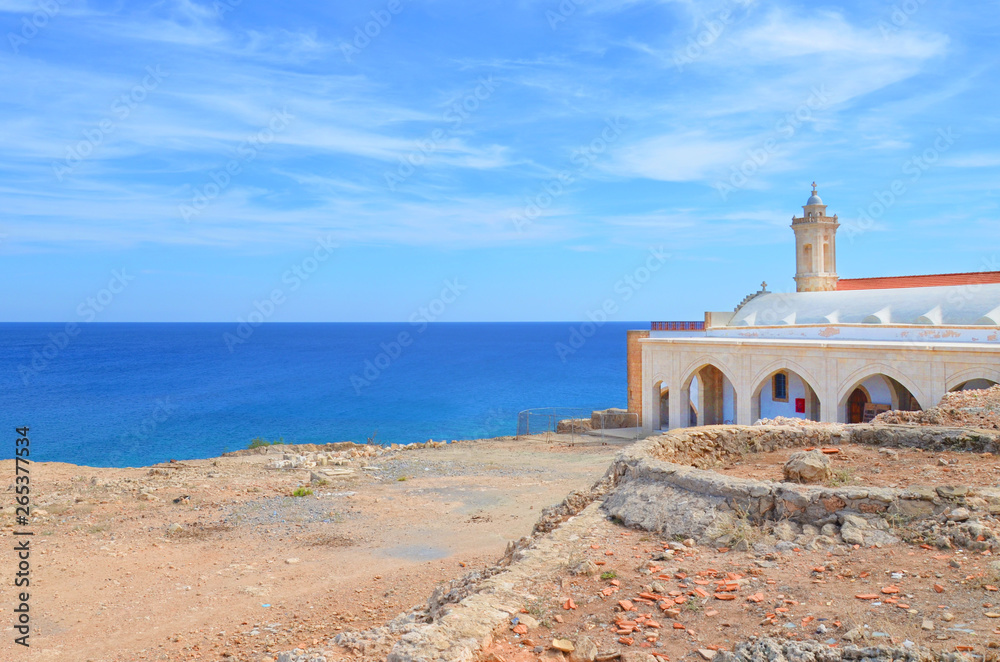 Amazing view of the Orthodox church Apostolos Andreas Monastery located in the Peninsula of Karpasia, Turkish Northern Cyprus taken on a sunny summer day with beautiful blue sea in the background. 