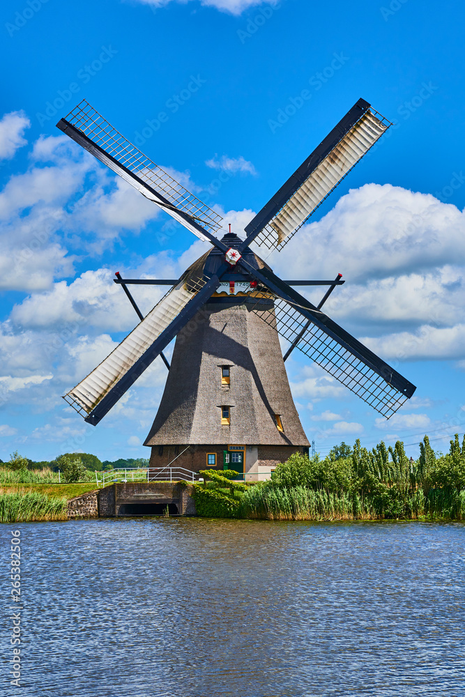 Netherlands rural lanscape with windmills at famous tourist site Kinderdijk in Holland. Old Dutch village Kinderdijk, UNESCO world heritage site. 