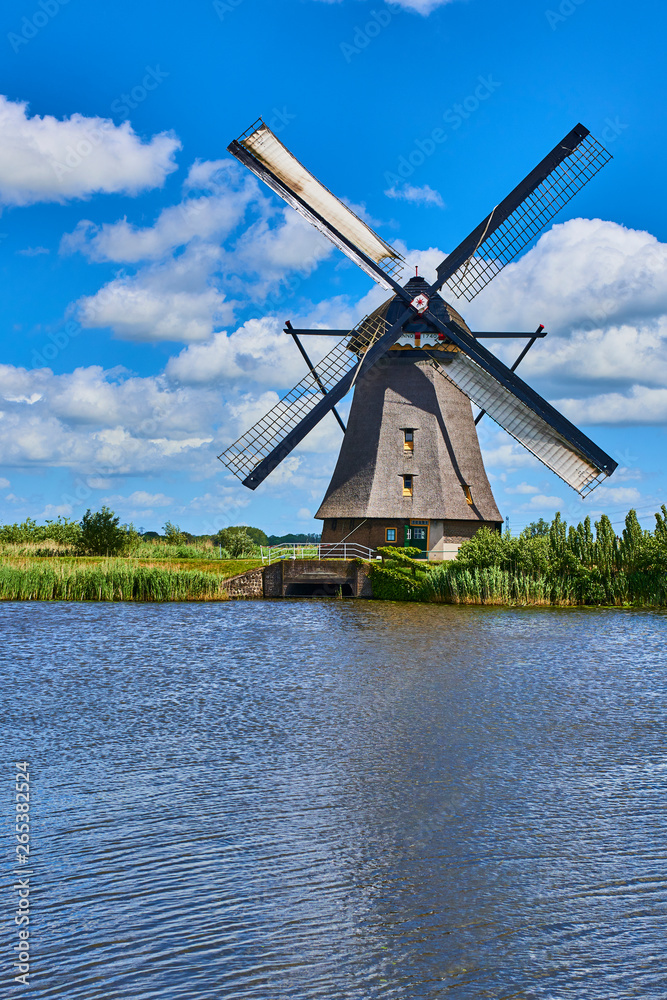 Netherlands rural lanscape with windmills at famous tourist site Kinderdijk in Holland. Old Dutch village Kinderdijk, UNESCO world heritage site. 