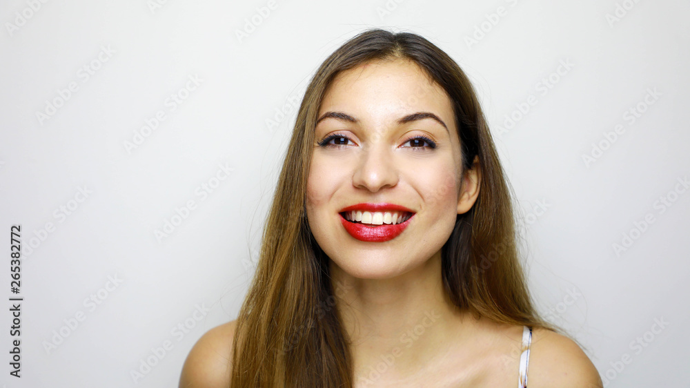 Portrait of young beautiful shy girl smiling looking at camera over white background Portrait of young beautiful shy girl smiling looking at camera over white background