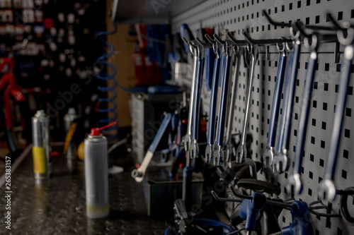 Repairman's workshop, close-up low-key image. Well organised workplace of a mechanic, rows of spanners and other tools