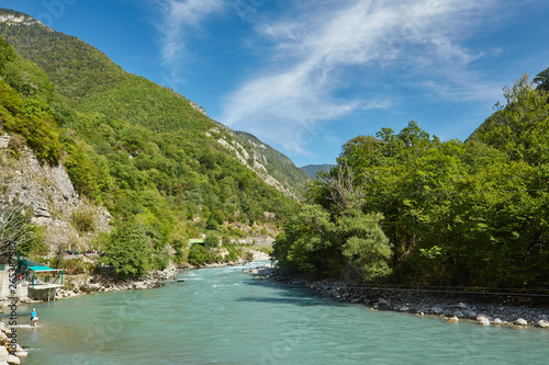 Landscape with mountains, forest and a river in front