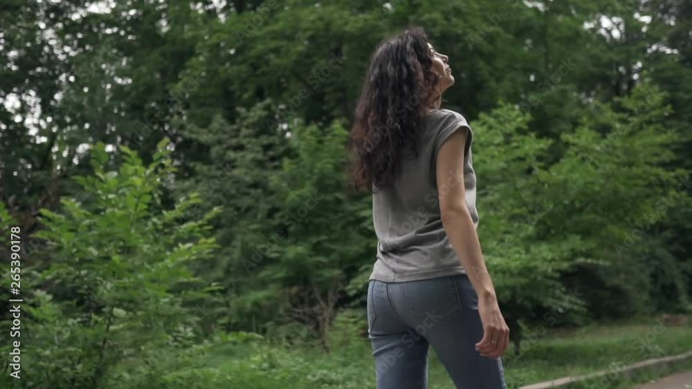 young beautiful curly brunette female smiling and walking young beautiful curly brunette female smiling and walking
