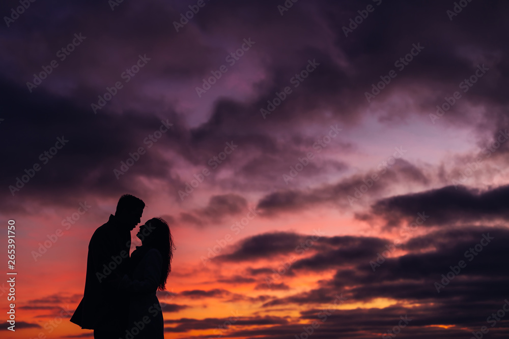 incredible view on couple kissing after sunset
