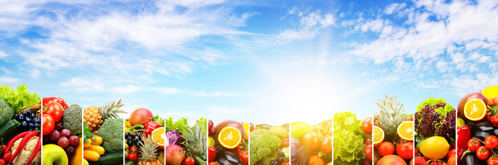 Variety vegetables and fruits against sky
