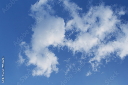 white  fluffy clouds on a blue sky background