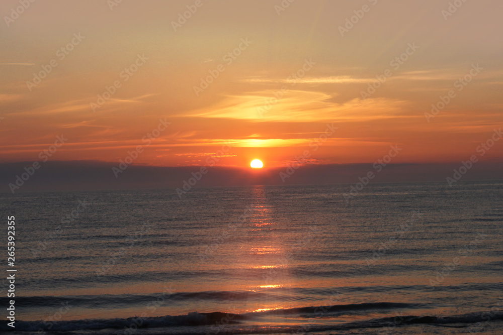 beautiful and romantic sea sunset in orange tones