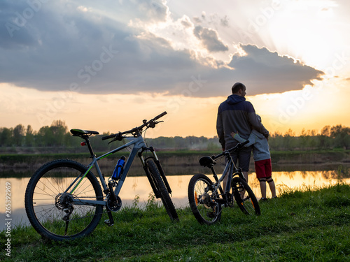 Family bike ride at sunrise