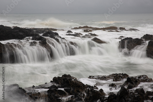 ocean wave crashing over rocky oregon coastline