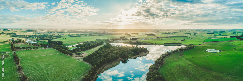 Wide aerial panorama of sunset over Hopkins River and grasslands in Warrnambool, Australia