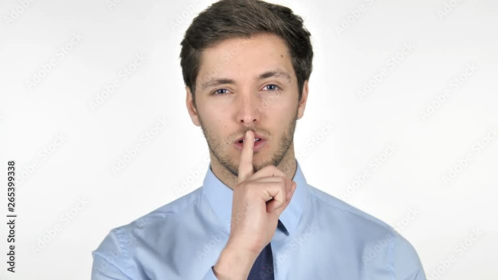 Finger on Lips by Young Businessman Isolated on White Background Finger on Lips by Young Businessman Isolated on White Background