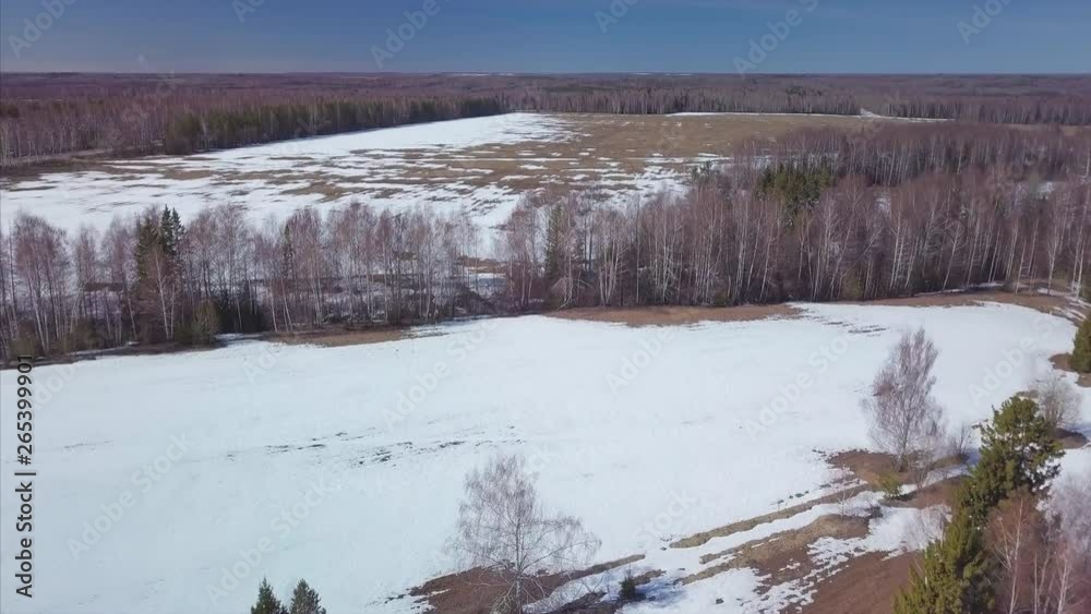 Flight over the spring forests and fields with snow patches. Russia Flight over the spring forests and fields with snow patches. Russia