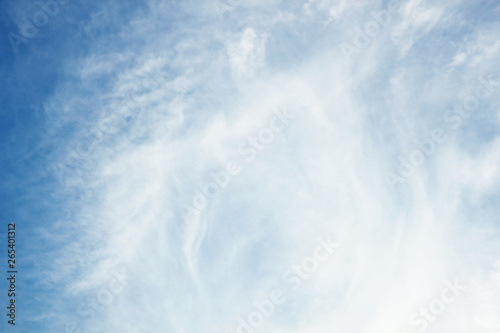 Clear open blue sky with clean soft white clouds and fresh weather during summer season. Large copy space area. For product art background, laptop wallpaper.