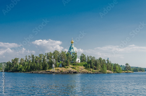 Beautiful view from the water to the island with the Orthodox Church. St. Nicholas Skete of the Valaam Monastery. Church of St. Nicholas. Karelia, Russia. photo