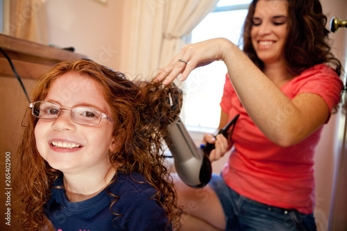 Mother Blowdrying Daughter's Hair at Home