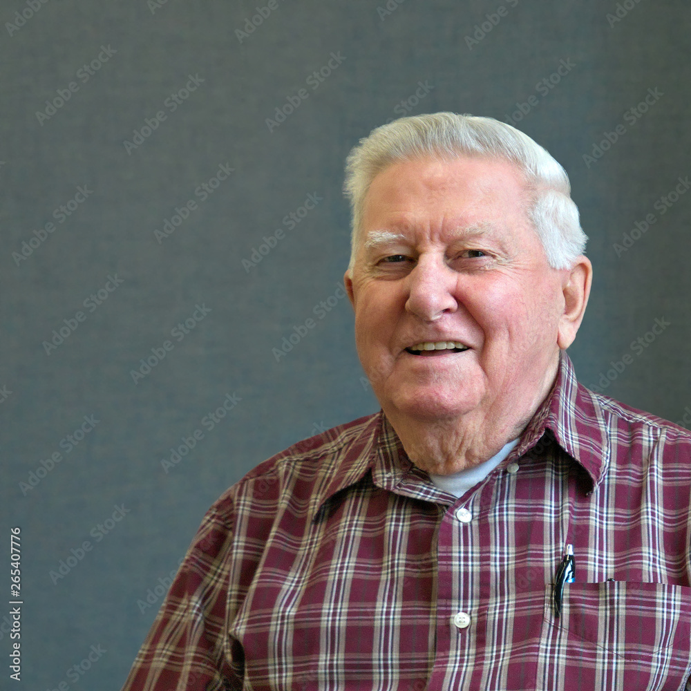 Senior octogenarian old man in plaid shirt with gray background. Senior octogenarian old man in plaid shirt with gray background.