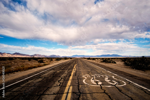 Landscape of cracked and broken pavement of route 66 lin the Mojave Desert.