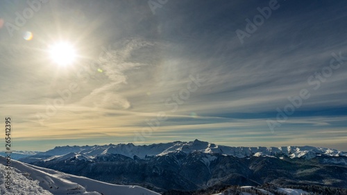 Bright sun over the Caucasus mountains covered by snow in the ski resort of Krasnaya Polyana, Russia. © Viacheslav