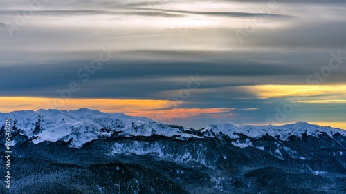 Sunset over the Caucasus mountains covered by snow in the ski resort of Krasnaya Polyana, Russia.
