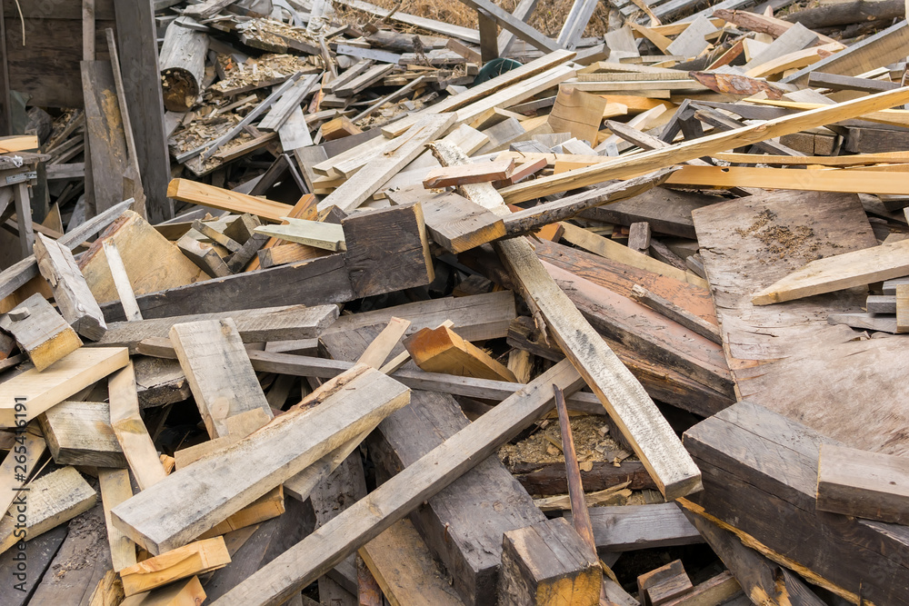 Piled in a pile of debris, pieces of boards, plywood and concrete blocks. Lumber, garbage, firewood Piled in a pile of debris, pieces of boards, plywood and concrete blocks. Lumber, garbage, firewood