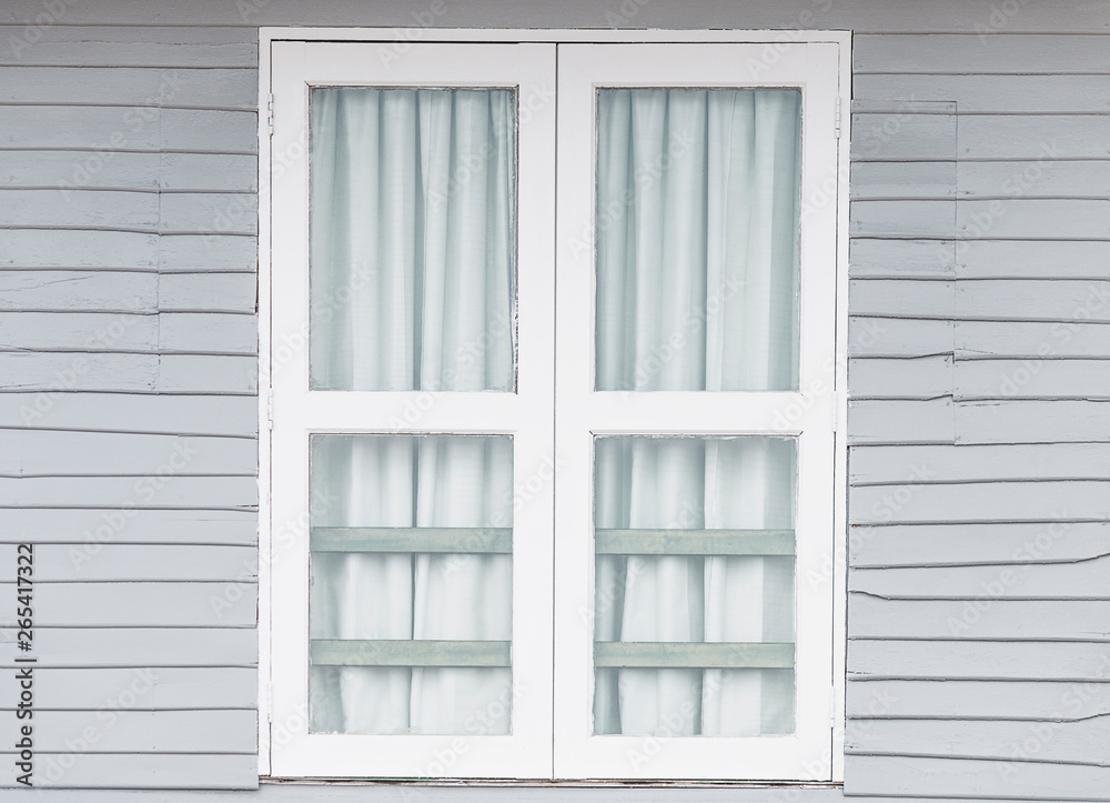 White window doors on old gray wooden houses. White window doors on old gray wooden houses.