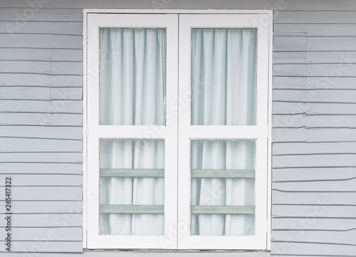 White window doors on old gray wooden houses.