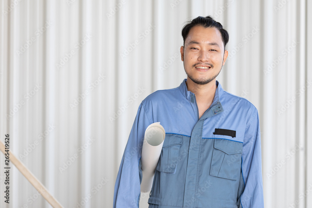 Portrait of male engineer with self-confidence and friendly manner, holding roll paper. Portrait of male engineer with self-confidence and friendly manner, holding roll paper.
